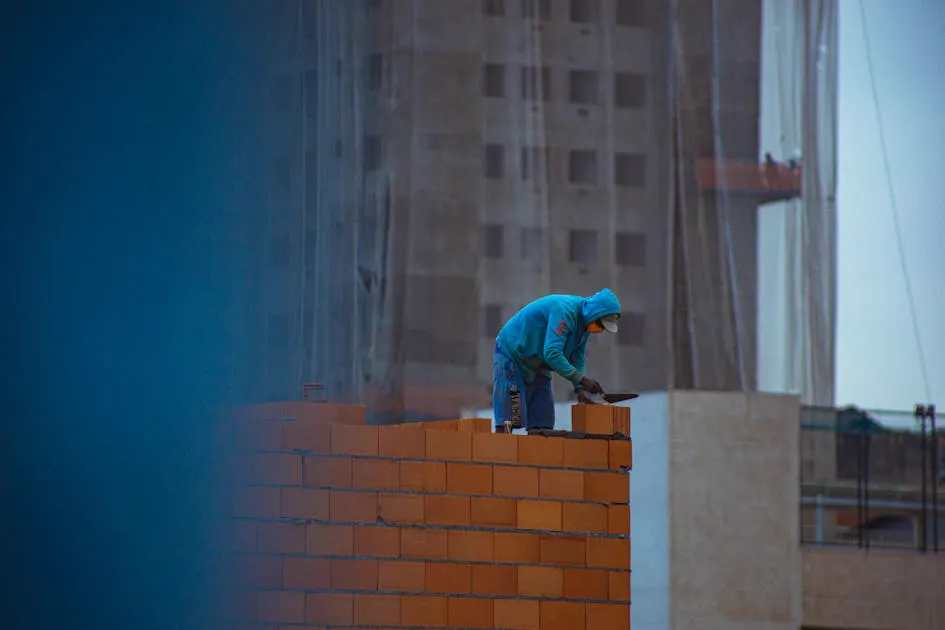 Builder laying bricks on a construction site