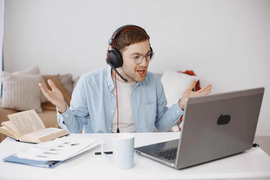 Frustrated man gesturing at laptop